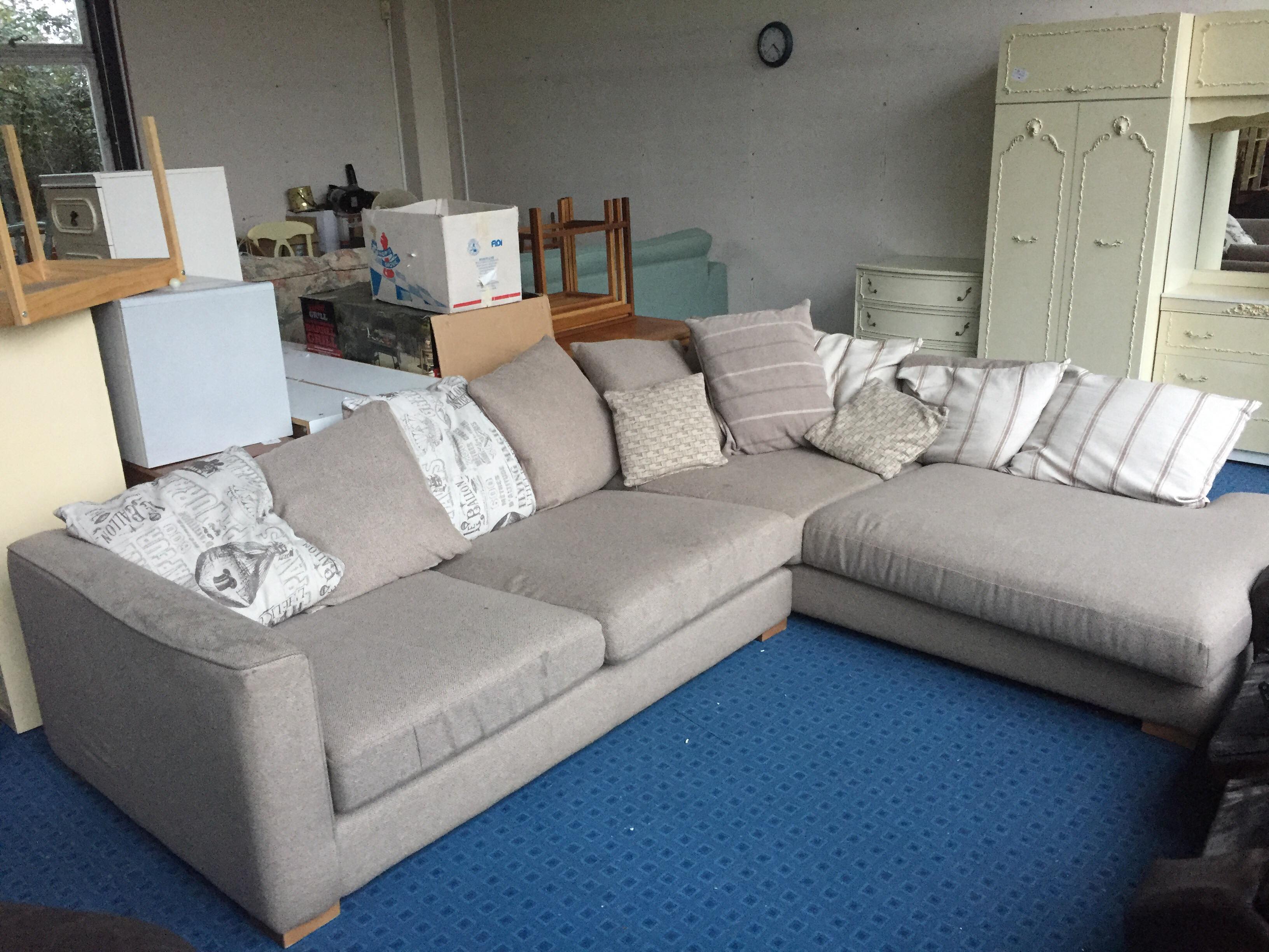 Large Beige corner sofa needs a good clean.