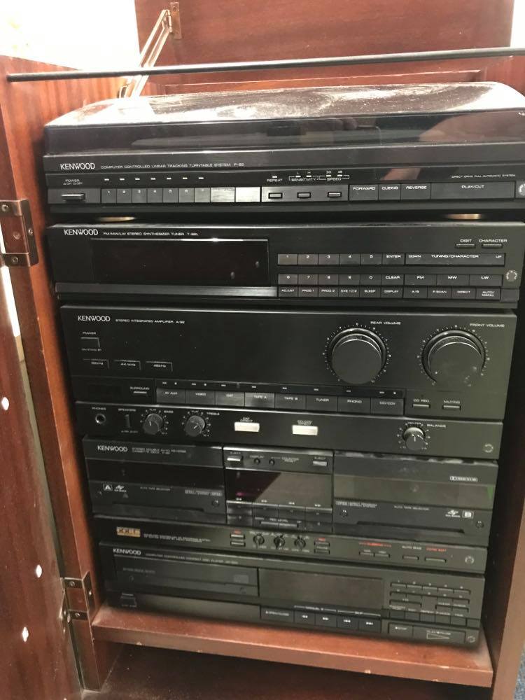 Kenwood Hi-Fi including turntable, digital tuner, amp, cassette deck and CD player. Complete with mahogany Hi-Fi cabinet with top opening and disguised door on front.