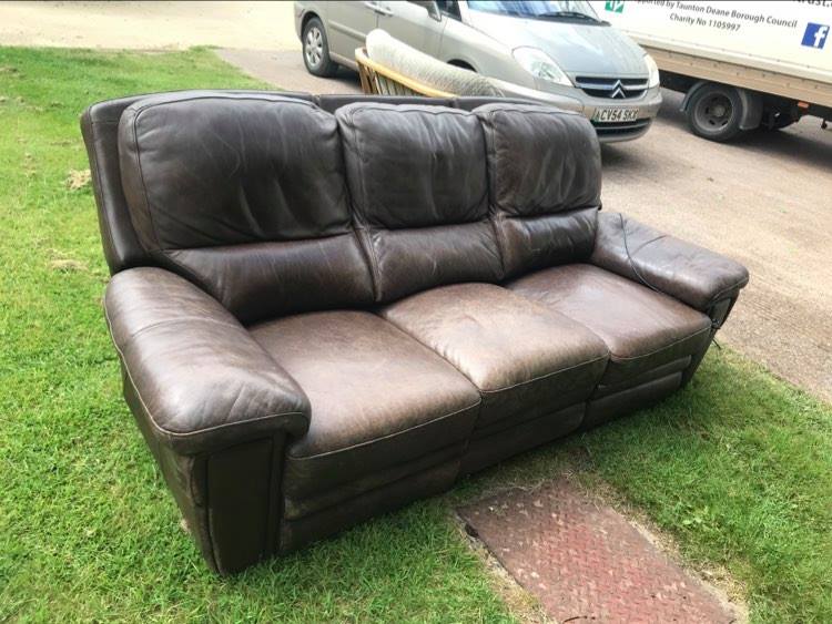 Three seater real leather sofa with electric reclining ends. Very heavy, thick real leather, would benefit from a deep cleaning / conditioning. Padding on arm has collapsed a bit hence the low price.