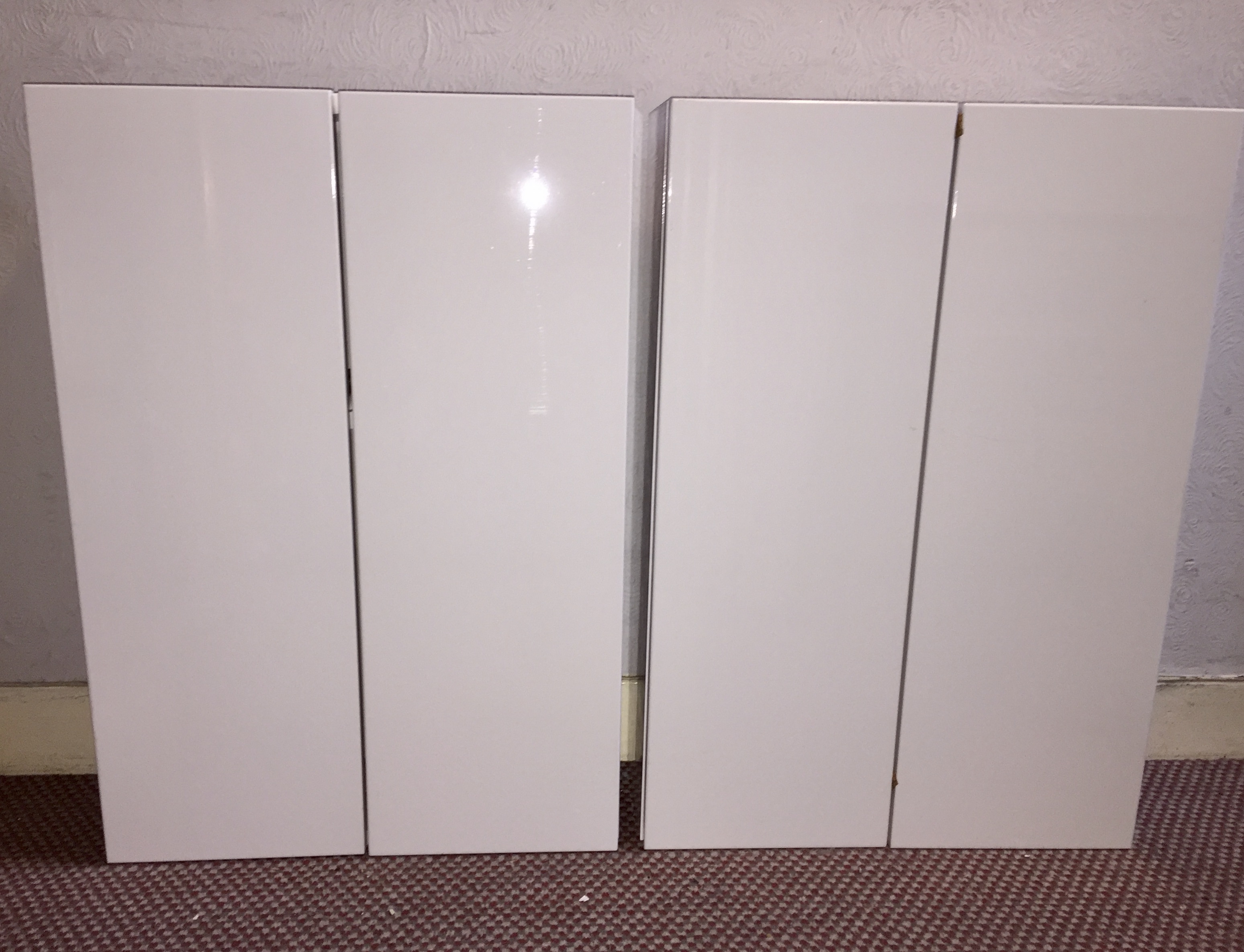Double bathroom cabinet - never used / installed. White gloss finish  72cm x 50 x 18.   Includes fittings.  Two available. One cabinet has a relatively small scratch on the front of one of the doors.  See photo.